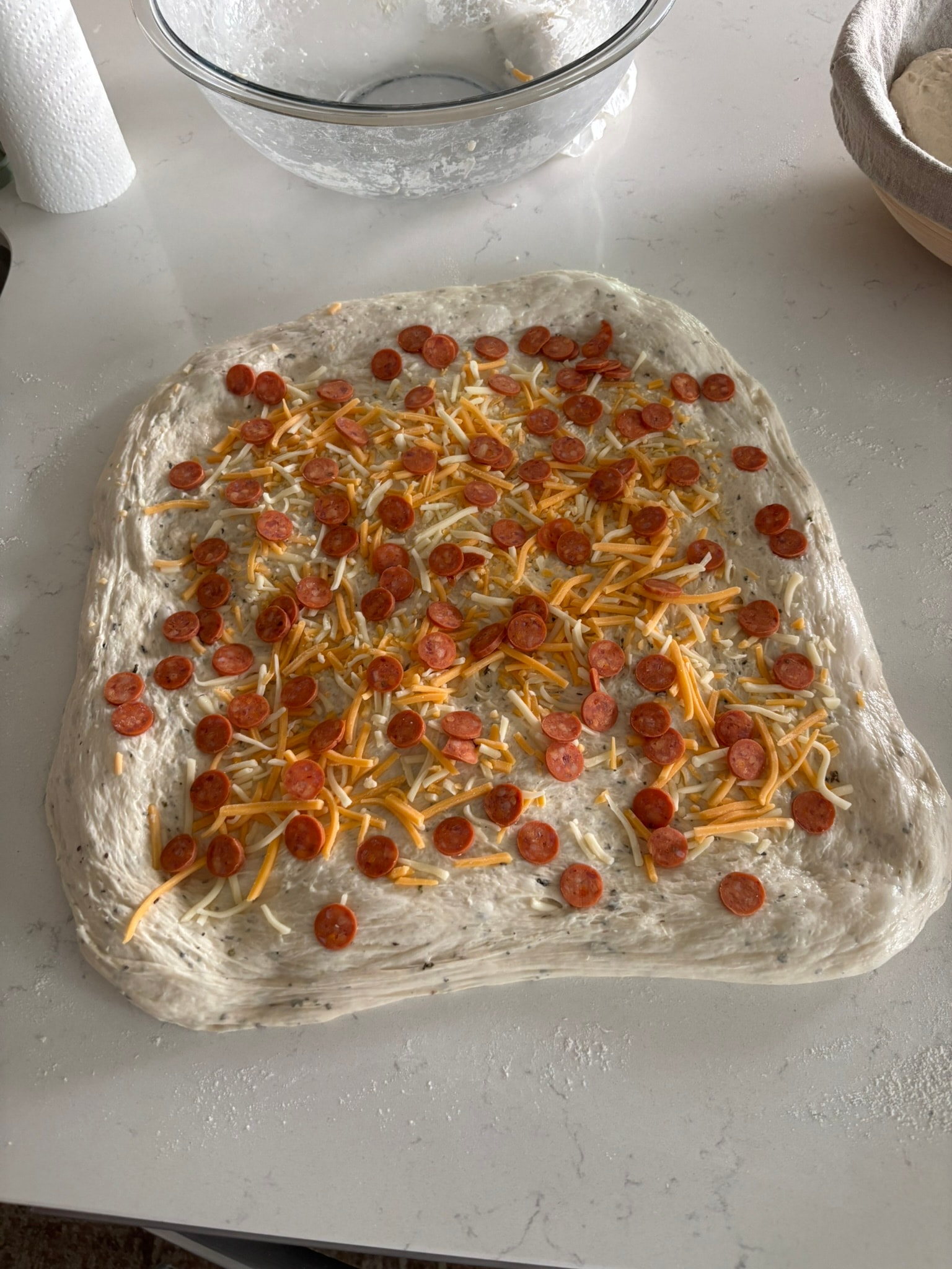 Cheesy pepperoni sourdough dough laid out with pepperoni and cheese before shaping, Kneadful Bread Co.
